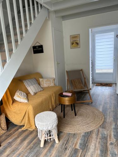 a bedroom with a bed and a stair case at Villa en bord de mer in Pornichet
