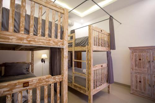 a bedroom with two bunk beds in a room at Seven Angels Villa and Hostel in Nusa Penida