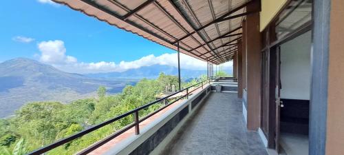 a balcony with a view of the mountains at The Kayuan in Kintamani