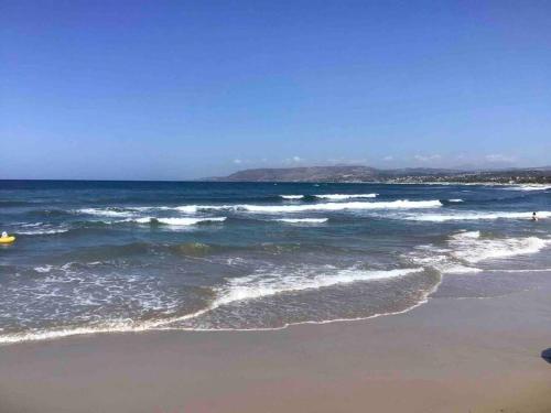 a beach with the ocean and the sand and waves at Studio with amazing view in Exopoli