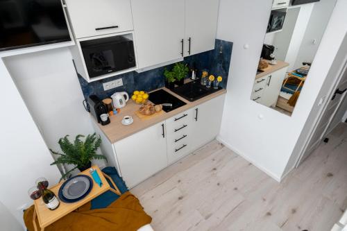 an overhead view of a kitchen with white cabinets at Czarnowiejska Micro Studio in Krakow