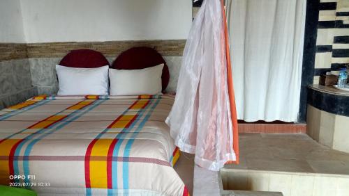 a bed with a colorful striped comforter in a bedroom at Rara Villas Lombok in Senggigi 