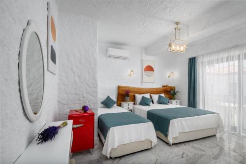 Habitación de hotel con 2 camas y espejo en Fethi Baba Konağı, en Izmir