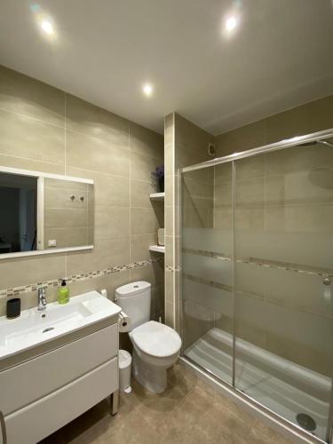 a bathroom with a shower and a toilet and a sink at Bellver 1, Ciutadella-Cala Blanca in Cala Blanca