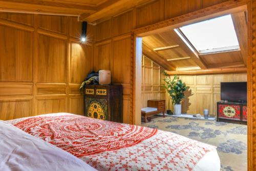 a bedroom with a bed and a skylight at The blue mountains on the moon in Shangri-La