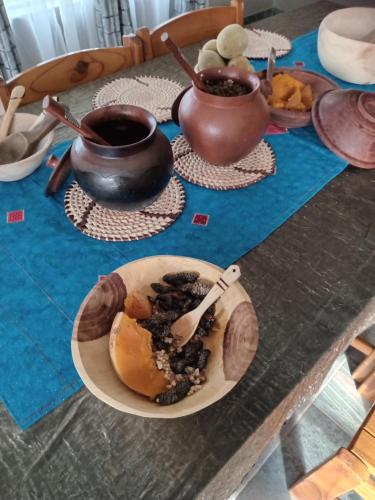 a table with a plate of food and a cup of coffee at Ledoba Bed & Breakfast in Molalatau