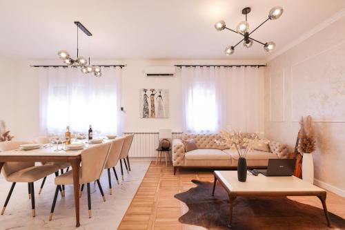 een woonkamer met een tafel en een bank bij Oscar & Leo Apartments in Zadar