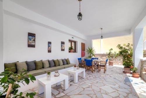 a living room with a couch and tables and chairs at Ifestos Villa in Fira