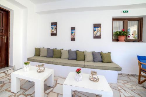 a living room with a couch and two tables at Ifestos Villa in Fira