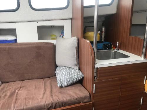 a couch in an rv with a sink at Baroudeur des mers in Le Havre