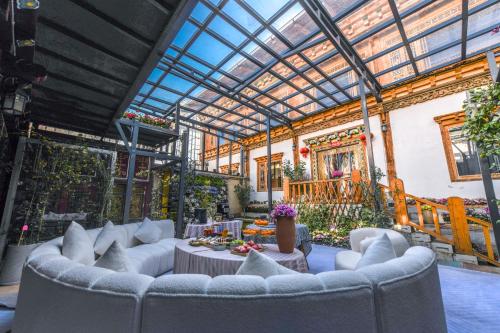 a living room with couches and a glass ceiling at The blue mountains on the moon in Shangri-La