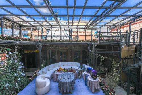 two people sitting at a table in a greenhouse at The blue mountains on the moon in Shangri-La