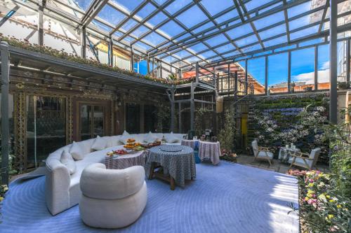 a conservatory with white furniture and a glass ceiling at The blue mountains on the moon in Shangri-La