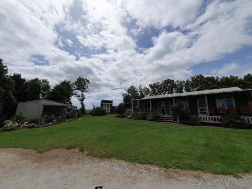 a yard in front of a house with a building at Hunts Farm - Te Kūiti in Te Kuiti