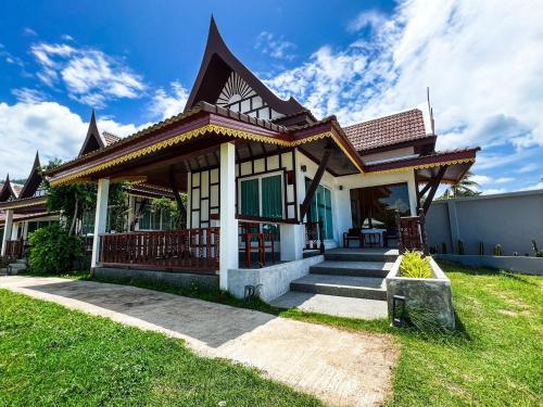 a small house with a porch and stairs to it at Aura Samui Best Beach Hotel - SHA Plus in Lamai