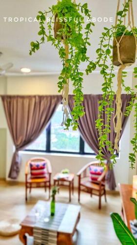 a living room with a table and some plants at Cozyhome Encorp Strand Alpha IVF 4px in Petaling Jaya