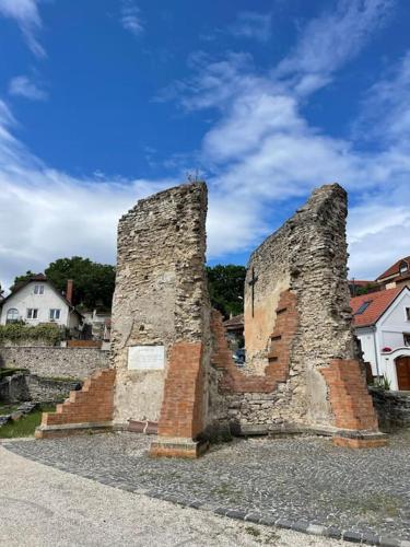 an old stone building with two towers on a street at Morris Vacka in Veszprém