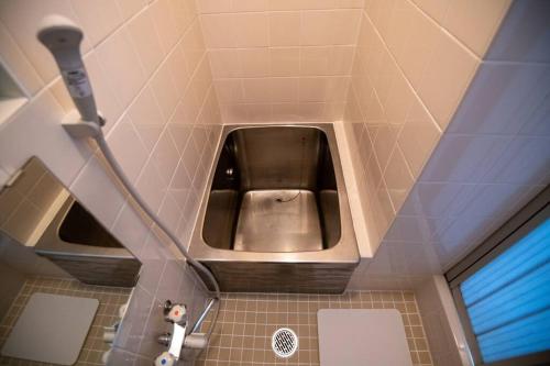 a bathroom with a toilet in the middle of a room at Rea東向島4丁目 in Tokyo