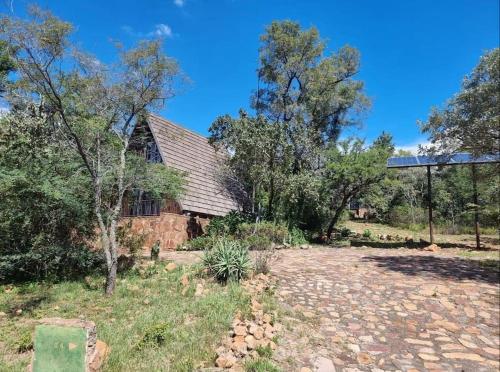 an old stone house in the middle of a field at Bietjie Bos Chalet in Rustenburg