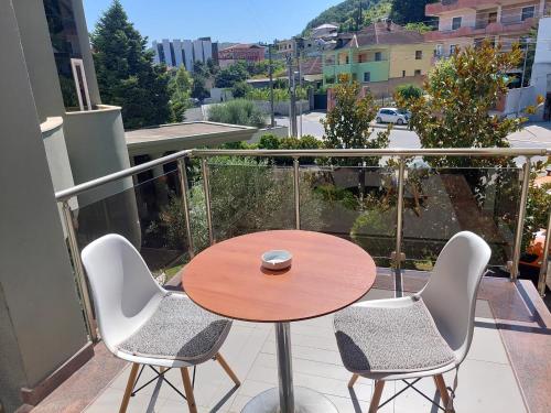 a table and two chairs on a balcony with a table and a table and chairs at Hotel Green in Tirana