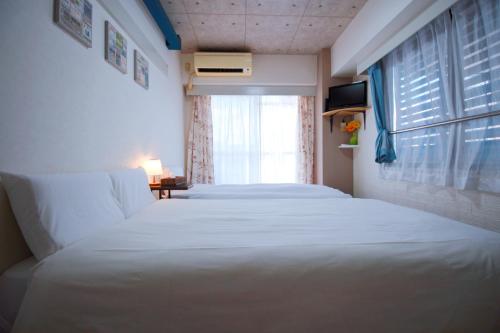 Postelja oz. postelje v sobi nastanitve HOTEL AARON通天東