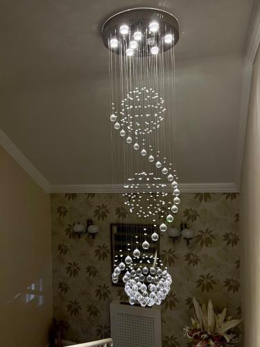 a chandelier hanging from the ceiling in a room at Hotel Forras in Komárom