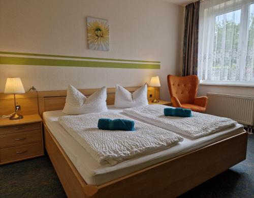 a bedroom with a bed with two pillows on it at Spreewaldhotel Seerose in Burg