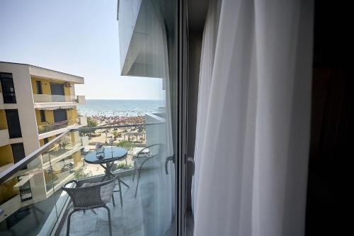 a room with a balcony with a view of the ocean at VDR Holiday Apartment 139 in Infinity Beach Resort - parking in Mamaia