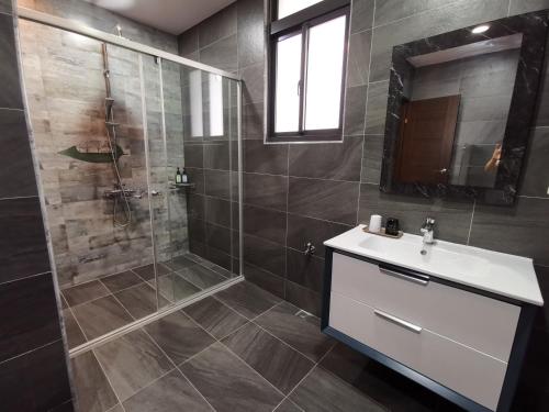 a bathroom with a shower and a sink and a mirror at Meets Anping in Tainan