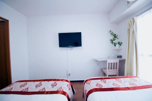 Cama ou camas em um quarto em HOTEL AARON通天西