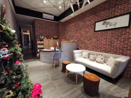 a living room with a christmas tree and a couch at Meets Anping in Anping