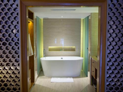 a bathroom with a white tub in a room at Hotel Gran Mahakam in Jakarta