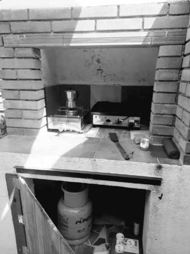 a kitchen with a stove in a brick oven at New Eco bungalow in Portorož