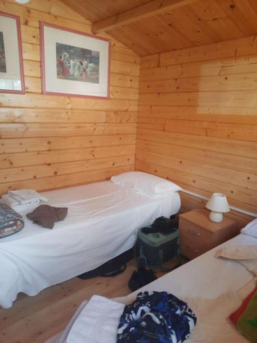 a bedroom with two beds in a log cabin at New Eco bungalow in Portorož