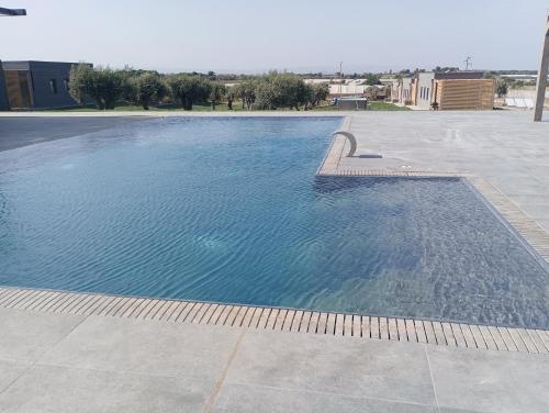 a large swimming pool in a parking lot at Agriturismo il Cappero b&b Marzamemi in Noto