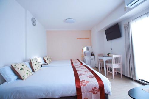 Cama ou camas em um quarto em HOTEL AARON通天西