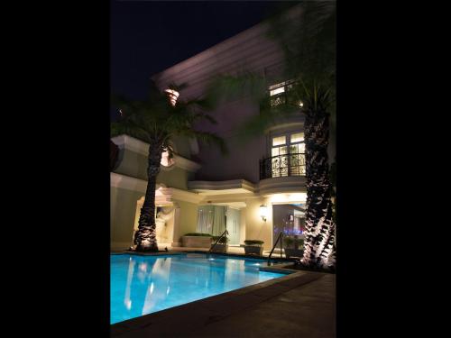 a house with a swimming pool at night at Hotel Gran Mahakam in Jakarta