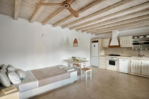 a large room with a bed and a kitchen at VLIA MAR Myconian Residences in Kalafatis