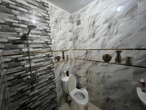 a bathroom with a toilet and a sink at Forêt appartement in Tangier