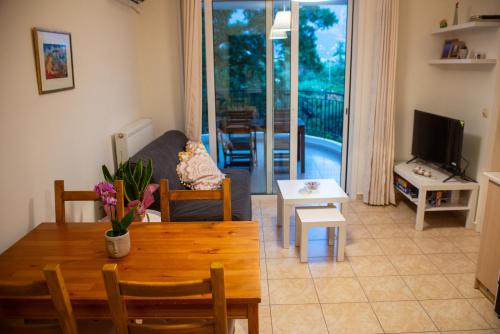 a living room with a couch and a table at Odysseas Home Kalamata in Kalamata