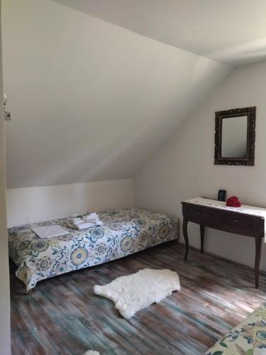 a bedroom with a bed and a desk in a attic at Villa Hani in Sarajevo