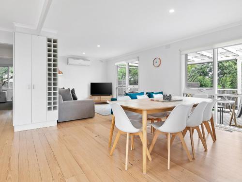 a white living room with a table and chairs at Rye Beach And Pool House by Ready Set Stay in Rye