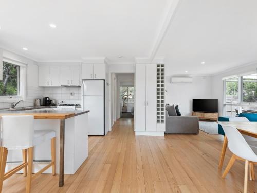 a kitchen and living room with a table and chairs at Rye Beach And Pool House by Ready Set Stay in Rye