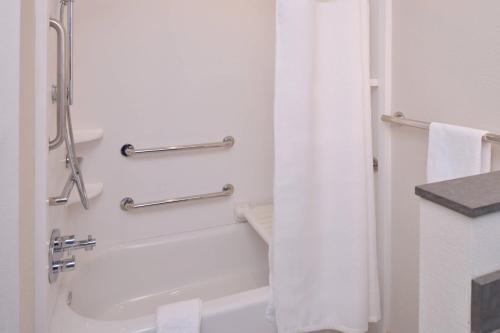 a bathroom with a tub and a shower with a shower curtain at Fairfield Inn & Suites by Marriott Columbus Grove City in Grove City