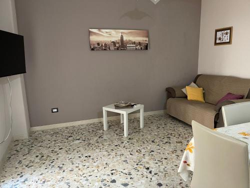 a living room with a couch and a table at Casa Aurora in Catania