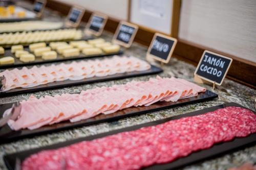 a bunch of different types of food on a counter at Hotel Compostela in Santiago de Compostela