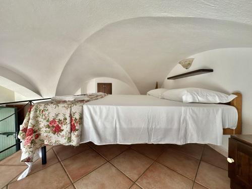een slaapkamer met een wit bed en een bloementafel bij Holidaycasa Lavinia - Luxury Sperlonga Suite in Sperlonga