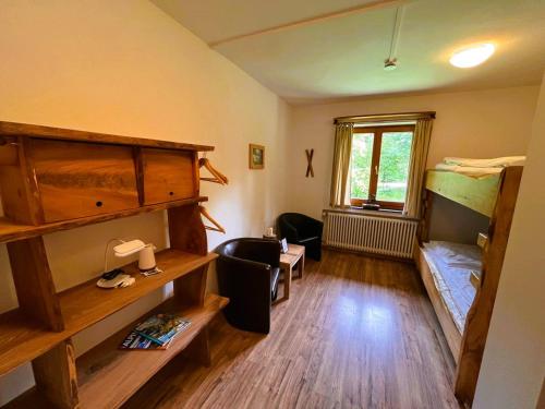 a room with two bunk beds and a desk at Toni Hütte am Riesserkopf in Garmisch-Partenkirchen