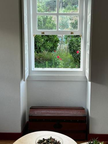 a window in a room with a table and a plate at Casa da Vila em Celorico de Basto in Celorico de Basto