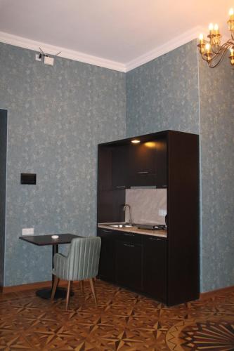 a kitchen with a table and a table and a chair at Hotel 1883 in Baku